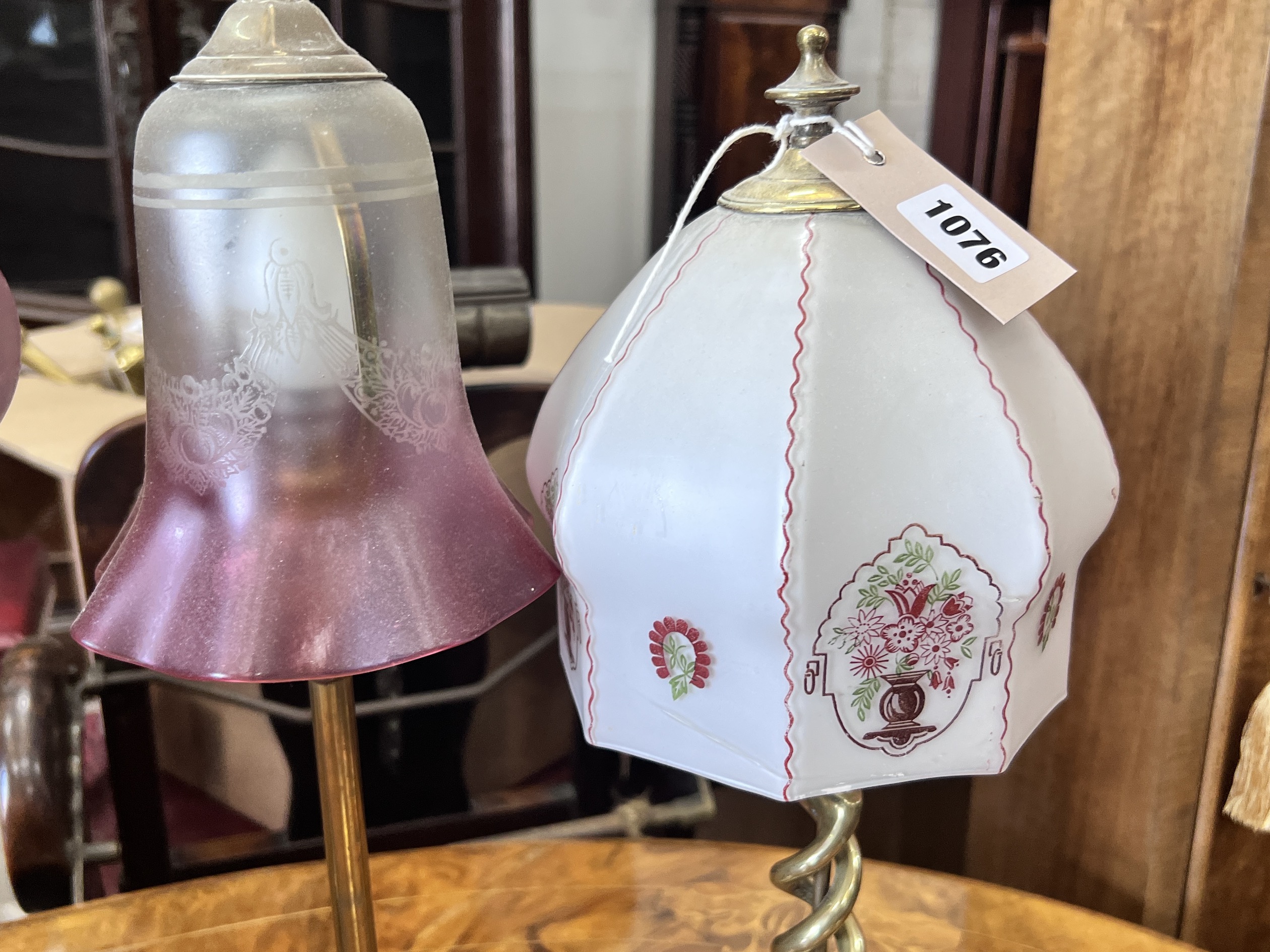 Two Edwardian silver plated and brass table lamps with etched cranberry shades and two converted candlestick lamps, tallest 50cm